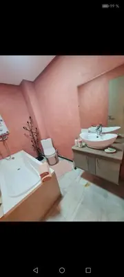 a bathroom with a sink and a tub and a toilet at Nilia in Marrakech