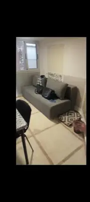a living room with a couch and a chair at Chambre individuelle studio in Marrakech