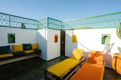 a room with a couch and chairs on a balcony at La Douiria Zaouia in Marrakech