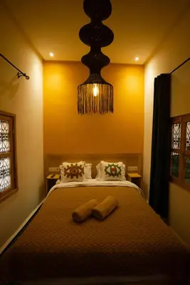 a bedroom with a bed with two towels on it at La Douiria Zaouia in Marrakech