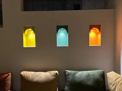four different colored windows on a wall at La Douiria Zaouia in Marrakech