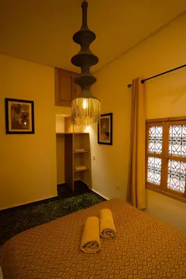a bedroom with a bed with two towels on it at La Douiria Zaouia in Marrakech