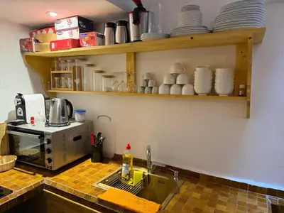 a kitchen with a sink and a counter with dishes at La Douiria Zaouia in Marrakech