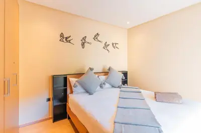 a bedroom with a bed with birds on the wall at Stylish Flat, Pool, Garden & Fast Wi-Fi in Marrakech