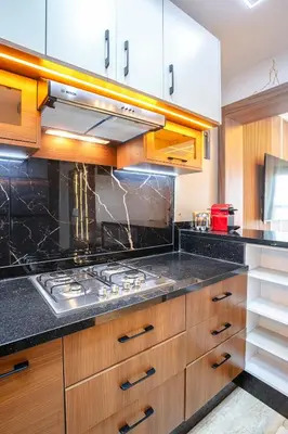 a kitchen with wooden cabinets and a stove top oven at The Soft Living - Marrakech Centre in Marrakech