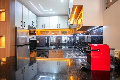 a kitchen with a red suitcase on a counter at The Soft Living - Marrakech Centre in Marrakech