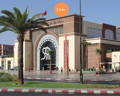 a building with a large doorway with a palm tree in front at The Blue Harmony - Hivernage Marrakech in Marrakech