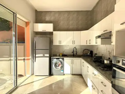 a kitchen with a refrigerator and a dishwasher in it at Friendly family home in a peaceful location in Marrakech