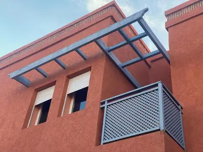 a building with a gate on the side of it at Friendly family home in a peaceful location in Marrakech