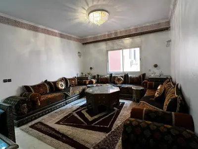 a living room with leather couches and a table at Luxurious Traditional & Modern Apartment Guéliz in Marrakech