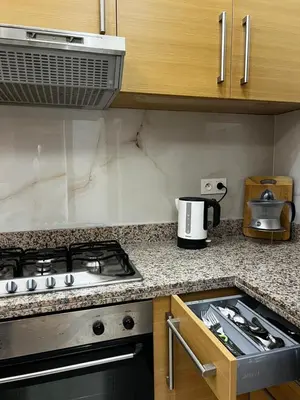 a kitchen with a stove and a counter top at Luxurious Traditional & Modern Apartment Guéliz in Marrakech