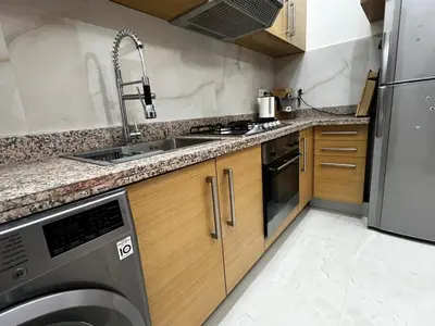 a kitchen with a sink and a dishwasher at Luxurious Traditional & Modern Apartment Guéliz in Marrakech