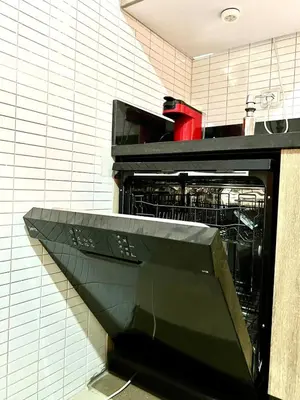 a dishwasher with its door open in a kitchen at Lovely Family aparts LAGUASSEM in El Gouassem