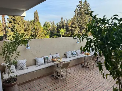a long couch with pillows on a patio at Riad Douha in Marrakech