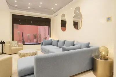 a living room with a couch and shoes on the wall at Duplex apart with parking by Sabor Voyage in Marrakech