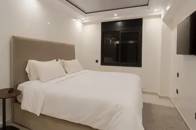 a bedroom with a white bed with a window at Duplex apart with parking by Sabor Voyage in Marrakech