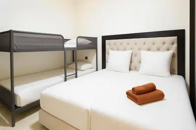 a bedroom with a white bed with a black headboard at Duplex apart with parking by Sabor Voyage in Marrakech