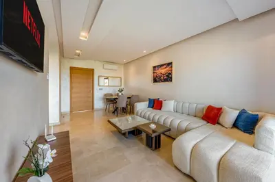 a living room with a couch and a tv at Comfy Flat 2 BedRooms-Argan Golf Atlas View in Marrakech