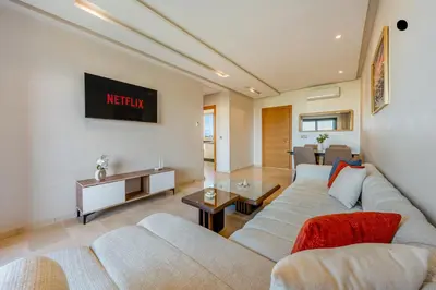 a living room with a couch and a table at Comfy Flat 2 BedRooms-Argan Golf Atlas View in Marrakech