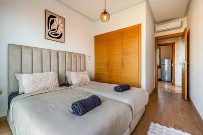a bedroom with a large bed with two pillows on it at Comfy Flat 2 BedRooms-Argan Golf Atlas View in Marrakech