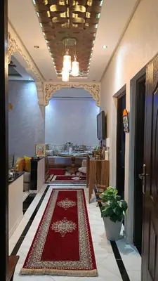 a living room with a red rug on the floor at Afaq marrakech in Marrakech