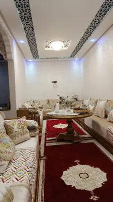 a room with couches and a table and a rug at Afaq marrakech in Marrakech