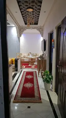 a hallway with a living room with a red rug at Afaq marrakech in Marrakech