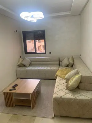 a living room with a couch and a coffee table at Nour 5 Marrakech Appartement in Marrakech
