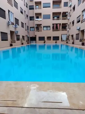 a large swimming pool in front of a building at Nour 5 Marrakech Appartement in Marrakech