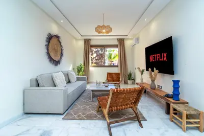 a living room with a couch and a tv at Modern Chic Apartment in Gueliz in Marrakech