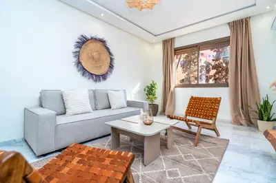 a living room with a couch and a table at Modern Chic Apartment in Gueliz in Marrakech