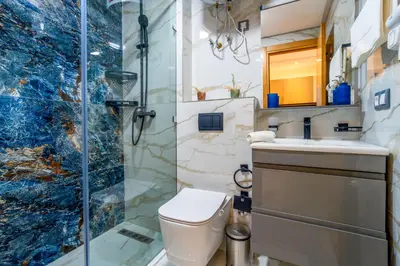 a bathroom with a shower and a toilet and a sink at Modern Chic Apartment in Gueliz in Marrakech