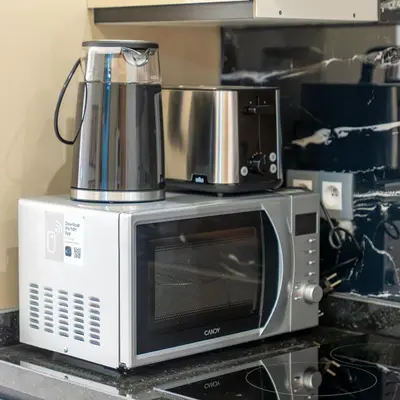 a microwave with a coffee maker on top of it at Modern Chic Apartment in Gueliz in Marrakech