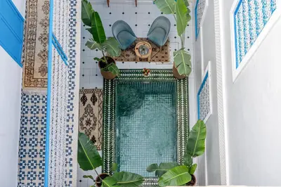 a bathroom with a mirror and potted plants at Riad Les Secrets De Marrakech in Marrakech