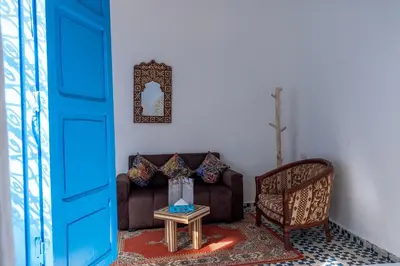a living room with a couch and a table at Riad Les Secrets De Marrakech in Marrakech