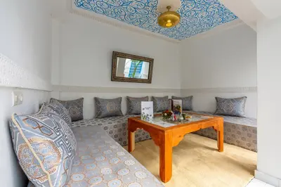 a living room with a couch and a table at Riad Les Secrets De Marrakech in Marrakech