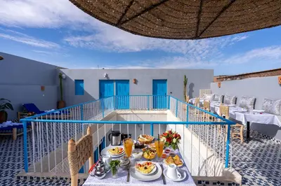 a breakfast table on the balcony of a villa at Riad Les Secrets De Marrakech in Marrakech