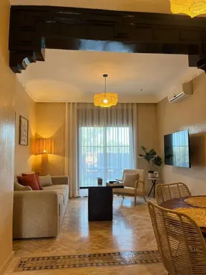 a living room with a couch and a table at Résidence Atlas Golf Marrakech in Marrakech