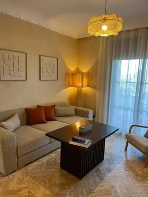 a living room with a couch and a coffee table at Résidence Atlas Golf Marrakech in Marrakech