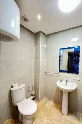 a bathroom with a white toilet and a sink at apartment chic 2 chambers in Marrakech
