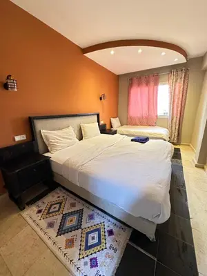 a bedroom with a large bed and a rug at apartment chic 2 chambers in Marrakech