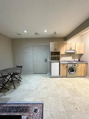 an empty kitchen with a table and a stove at apartment chic 2 chambers in Marrakech