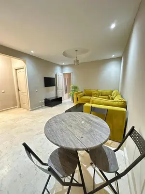 a living room with a table and a couch at apartment chic 2 chambers in Marrakech