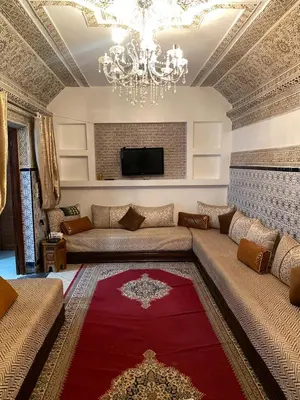 a living room with a couch and a chandelier at Majorelle City Apartment in Marrakech