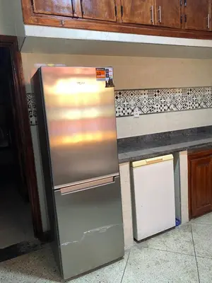 a stainless steel refrigerator in a kitchen next to a counter at Majorelle City Apartment in Marrakech