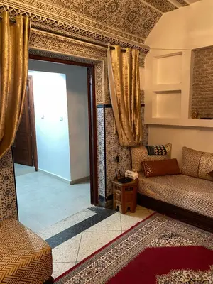 a living room with a couch and a glass door at Majorelle City Apartment in Marrakech