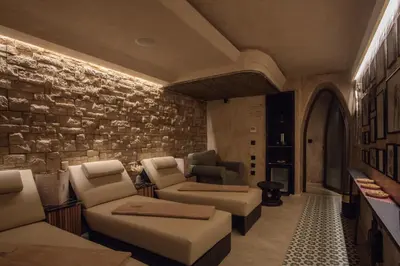 a living room with couches and a brick wall at Riad Kalemat & Spa in Marrakech
