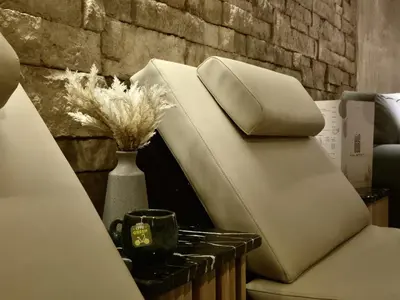 a white couch with a vase and a cup on a table at Riad Kalemat & Spa in Marrakech