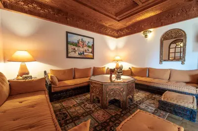 a living room with a couch and a table at Cozy Quiet Traditional Apartment in Dar Caïd Layadi