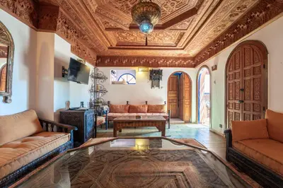 a living room with a couch and a table at Cozy Quiet Traditional Apartment in Dar Caïd Layadi
